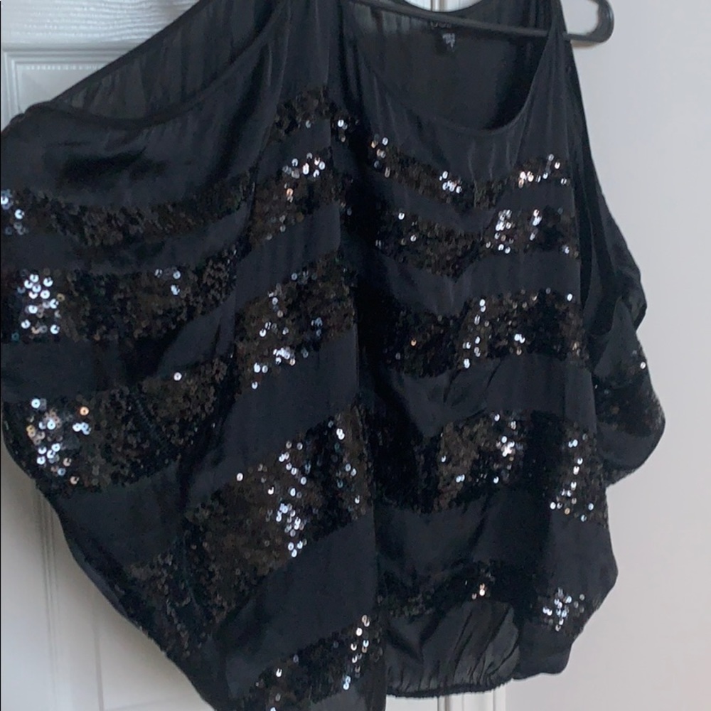 Super Cute Bebe, off the shoulder, sequined shirt.